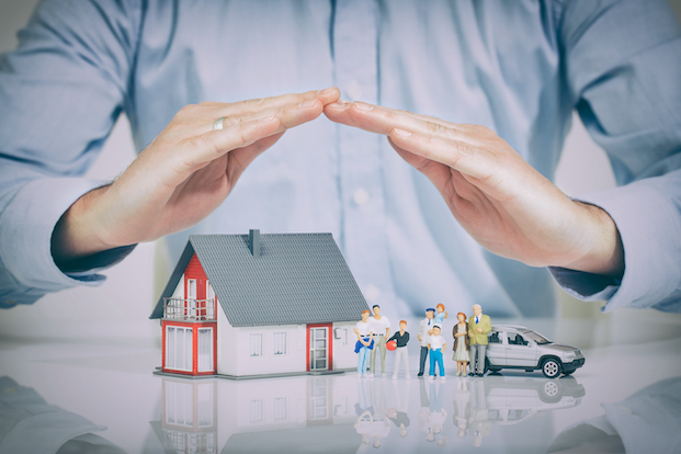 A person holding there hand above a home